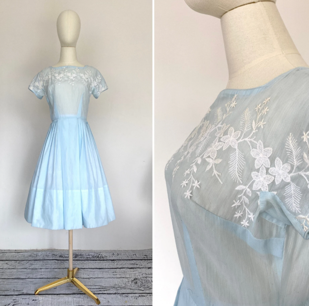 1950s Fashion: Vintage 1950s 'Dauphine' light blue embroidered dress with a full skirt. Dauphine, a label designed for petite sizes, was introduced in 1958 and manufactured through at least 1971.