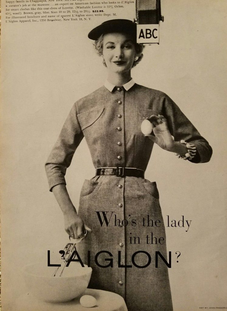 1950s vintage fashion ad for L'Aiglon dresses featuring a woman cooking while standing in front of ABC microphone wearing a coat-dress from L'Aiglon. Beautiful 1950s fashion.