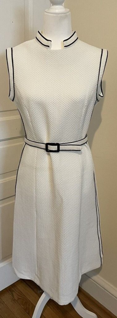 1960s Fashion: 1960s L'Aiglon White with black trimmings shift dress with belt. 