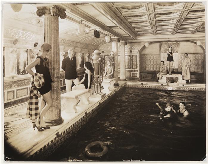 1920s photo of the "M.S. 'Saturnia', Pompeian indoor swimming pool" featuring stylish people in 1920s swimsuits.