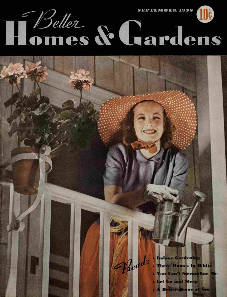 1930s vintage magazine for Better Homes & Gardens from September 1938 featuring a cover model on her balcony garden holding a watering can and wearing a wide brim hat. 