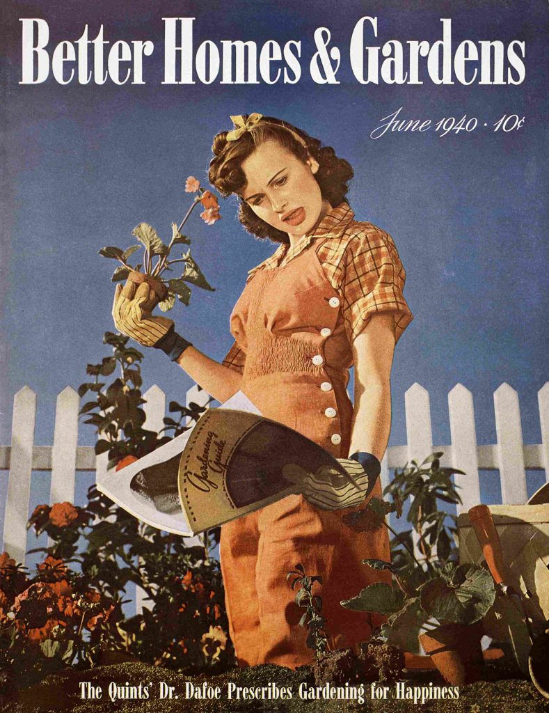 1940s vintage magazine for Better Homes & Gardens June 1940 featuring a woman with 1940s hairstyle and ribbon in her hair in overalls standing in her flower garden with a question mark on her face. 