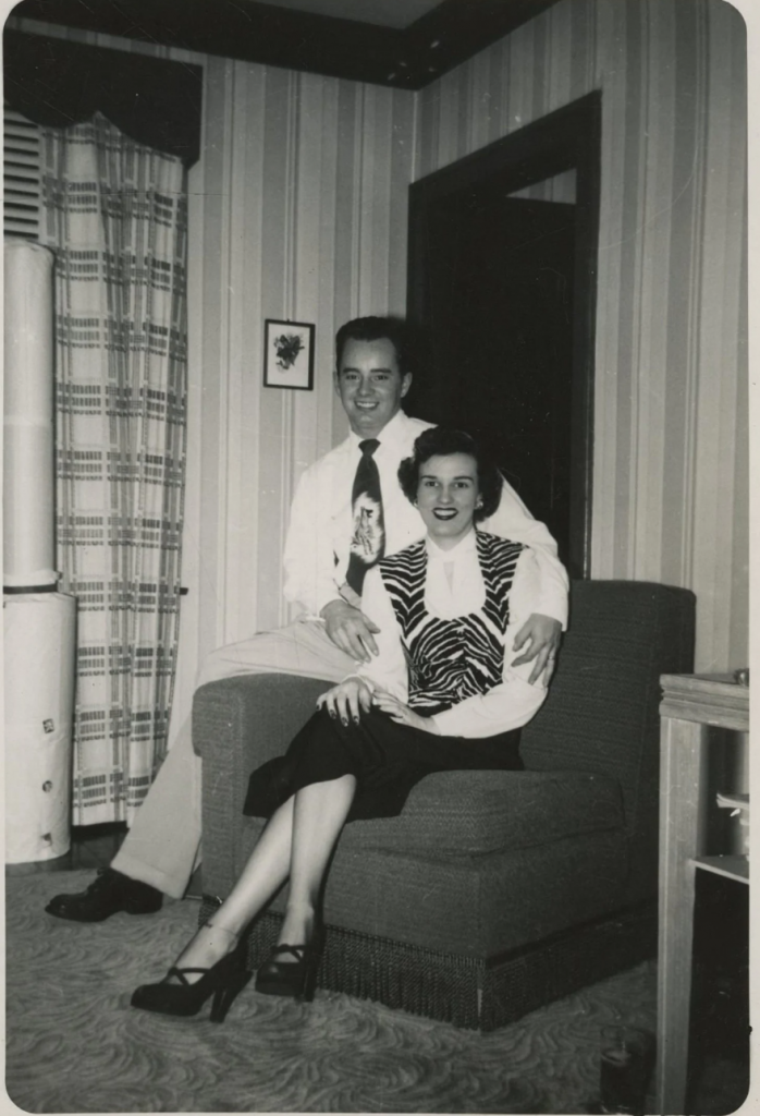 1940s photo or an early 1950s, whatever the age our happy couple posing for a photo on their comfest living room chair are doning some pretty fantastic fashions. From our husbands tie with an image on it to our lovely wifes zebra stripped shoes and cute heels, this couple knows how to dress.