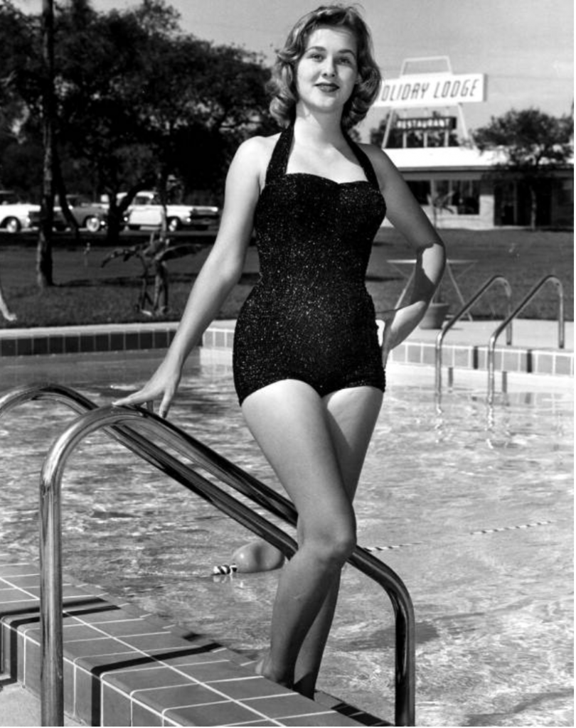 Late 1950s / Early 1960s photo of a A young woman in sparkly halter top swimsuit posing at the poolside - Panama City, Florida.