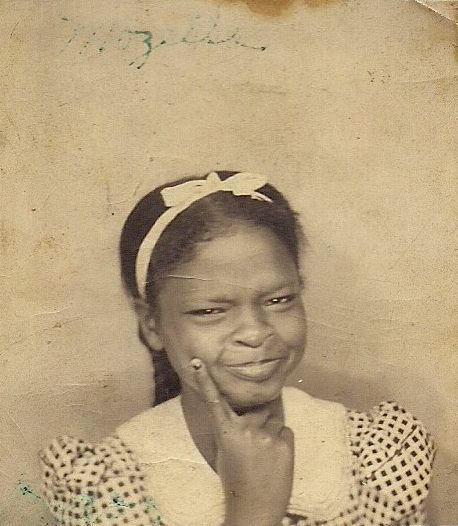 1930s vintage photo booth image of a young Black girl having fun with the camera. 