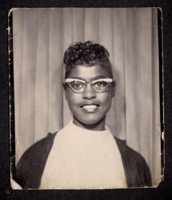 1950s vintage photo booth image of a pretty young Black women with cat eye glasses