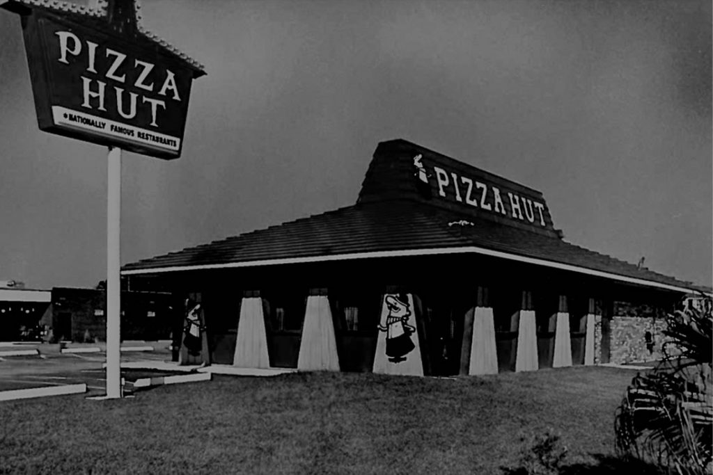 1960s vintage photo of The iconic Pizza Hut building style was designed in 1963 by Chicago architect George Lindstrom and was implemented in 1969