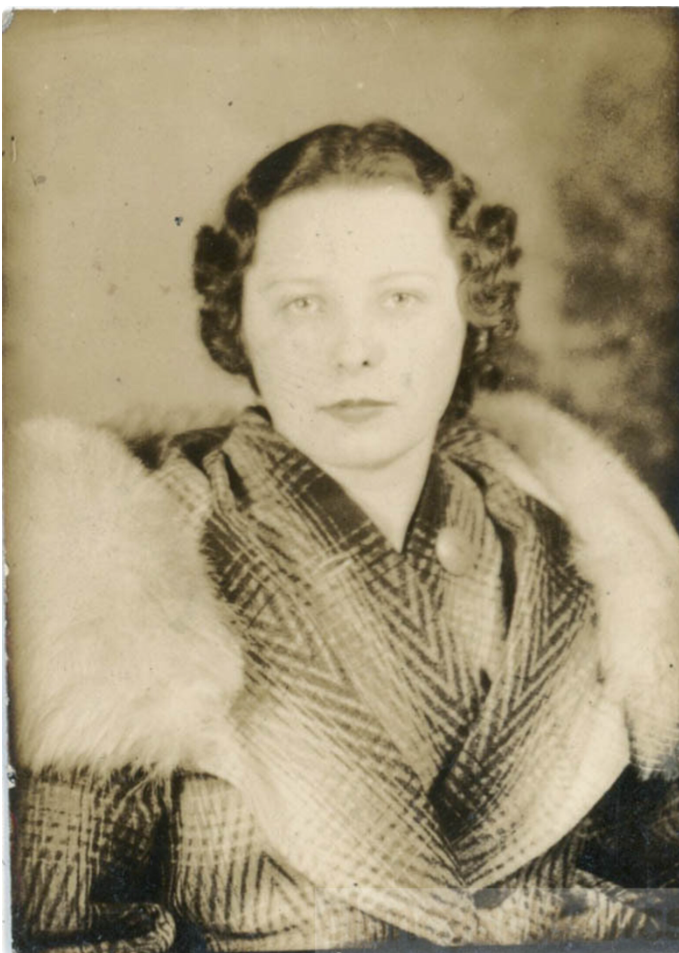 1930s vintage photo booth image of a woman in a coat with a fun collar and 1930s hairstyle from 1938