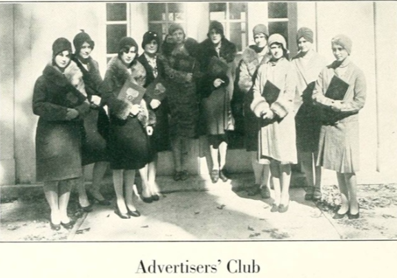 Late 1920s vintage yearbook photo from 1929 from William Peace University featuring an image of the Advertisers Club. A group of young women in late 1920s coats & hats holding binders. 