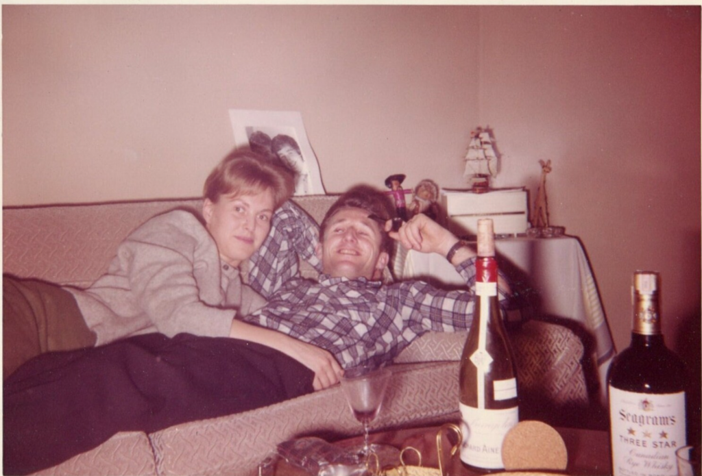 1950s vintage photo of a couple  Snuggling on a Couch Enjoying a Few Drinks