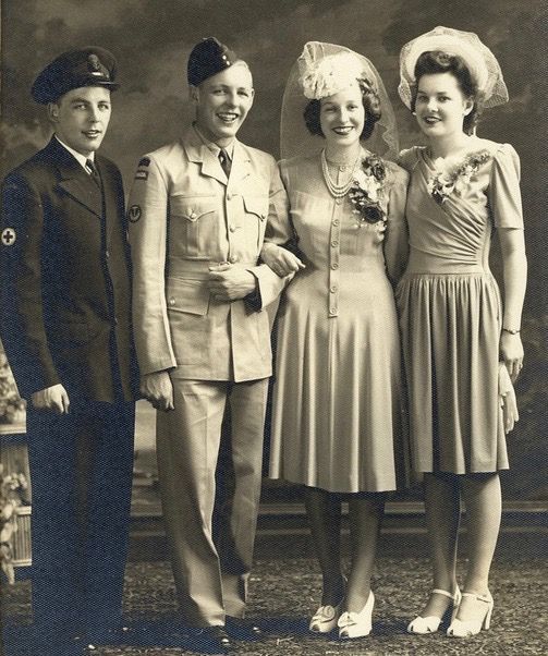 1940s Vintage Wedding Photo of a Soldier and his bride posing for their wedding photo in 1943 in 1940s fashions with the bridesmaid and the groomsman. The men are in uniform. 