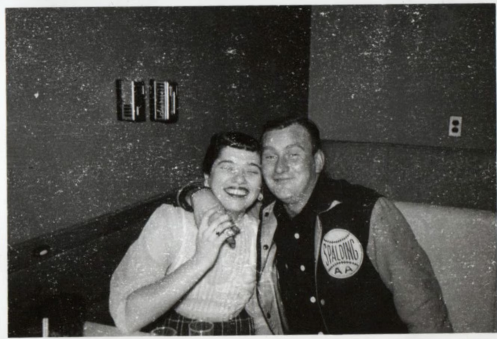 1950s vintage photo of a man in a varsity jacket letterman jacket with his arm around a 1950s woman