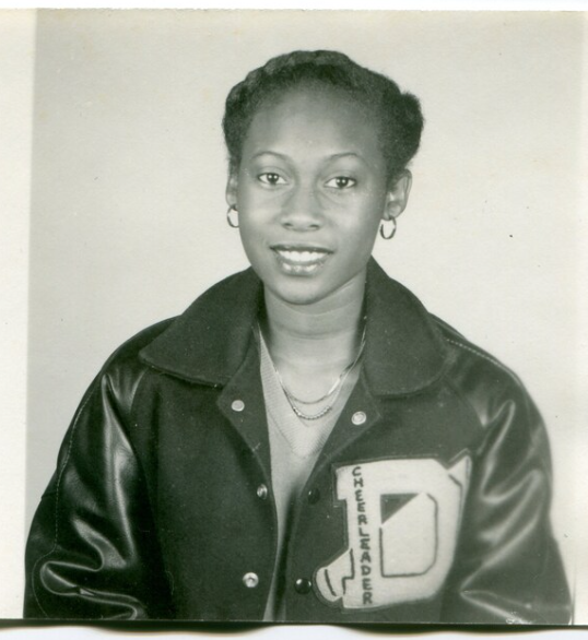 1950s vintage photo of a young Black woman in a cheerleader letterman jacket varsity jacket