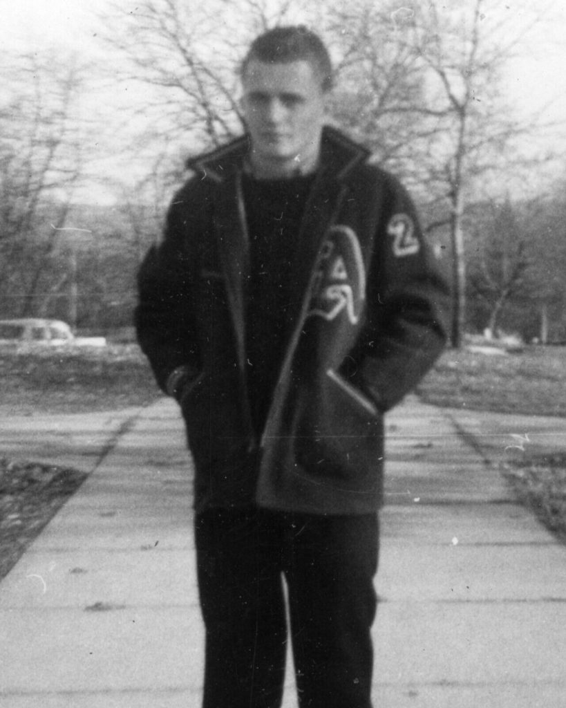 1950s photo of a young man in a letterman jacket / Varsity Jacket. 