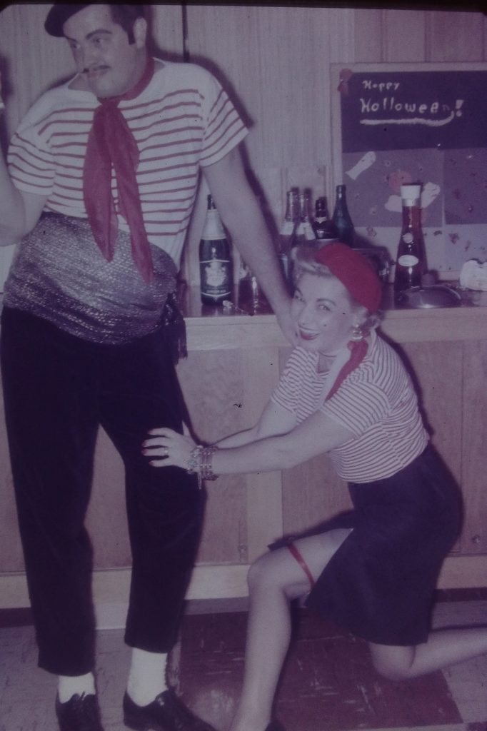 1960s vintage halloween party photo featuring a couple dressed a two french people. Photo is from a basement party in 1967.