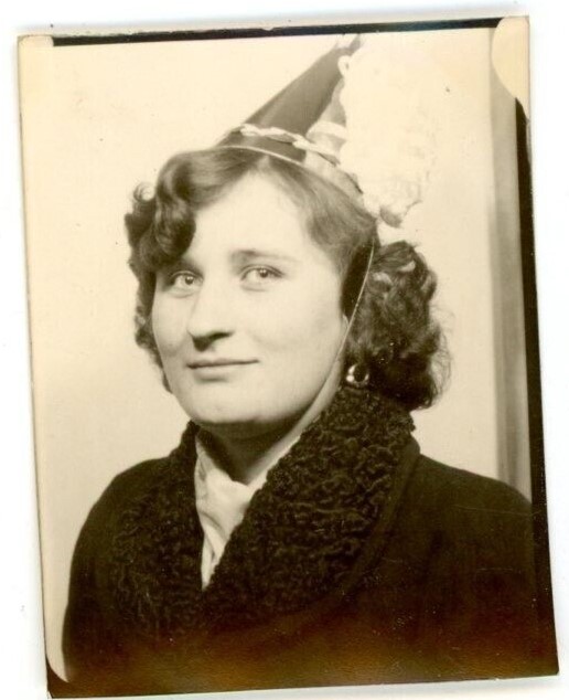 1930s or 1940s vintage photo of a young woman in a photo booth wearing a New Years Eve Party Hat 