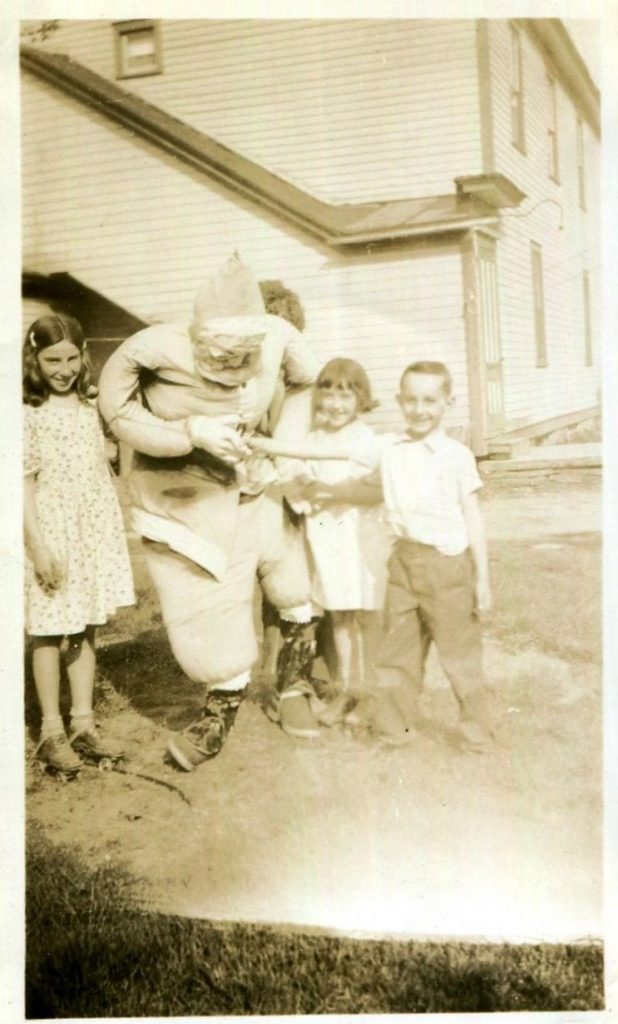 1930s 1940s vintage photo of kids playing with a large stuffed Santa Claus outside