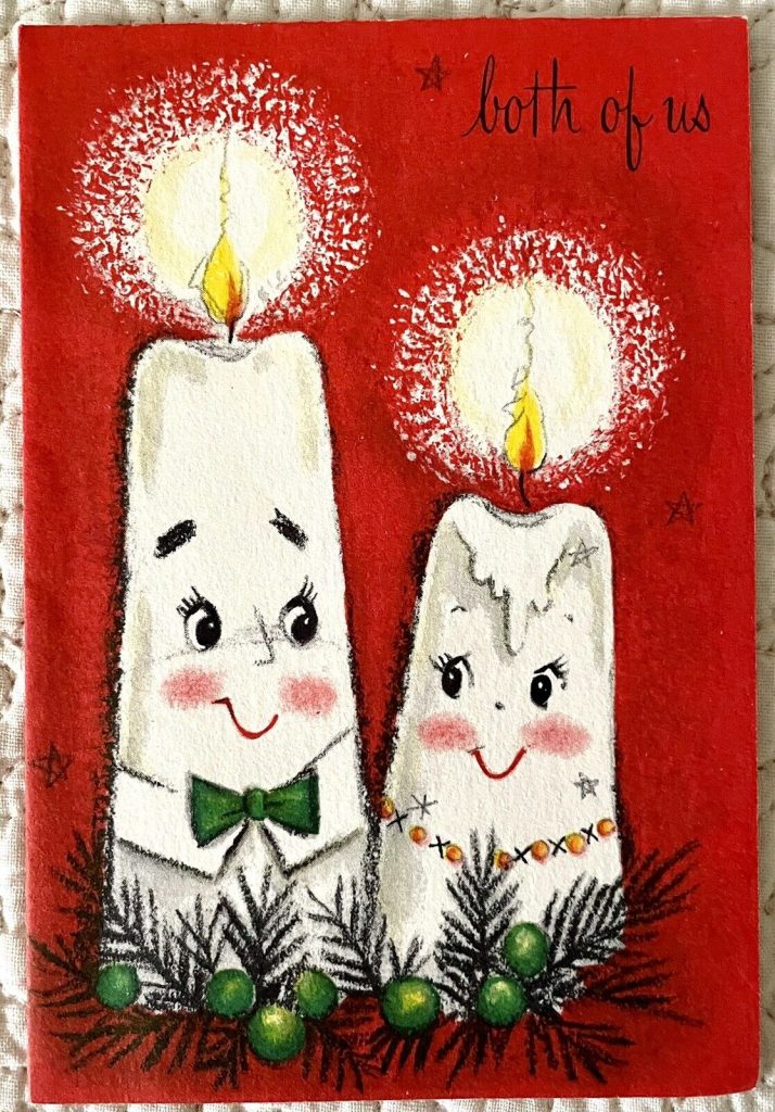 1950s  / 1960s vintage christmas card with an illustration of two candles wishing a merry christmas. 