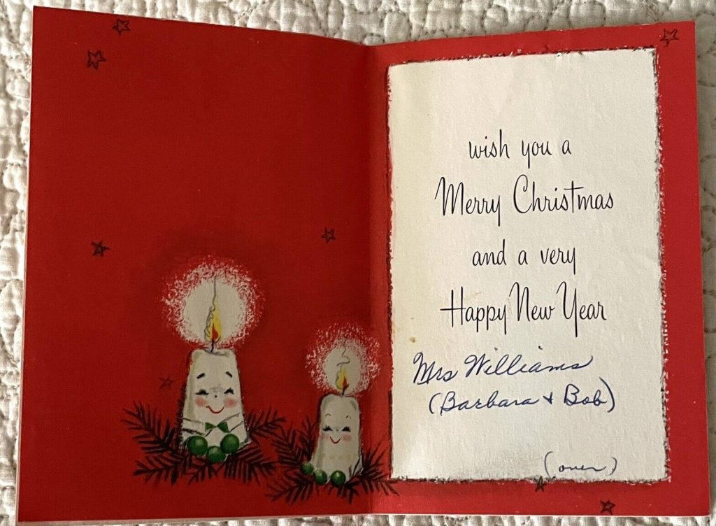 1950s  / 1960s vintage christmas card with an illustration of two candles wishing a merry christmas. 