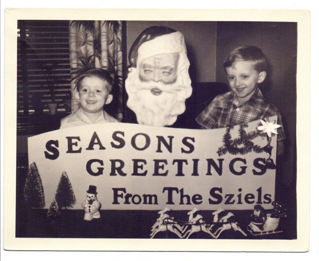 1950s 1960s vintage christmas card from Germany featuring two kids with a plastic santa holding a seasons greetings sign