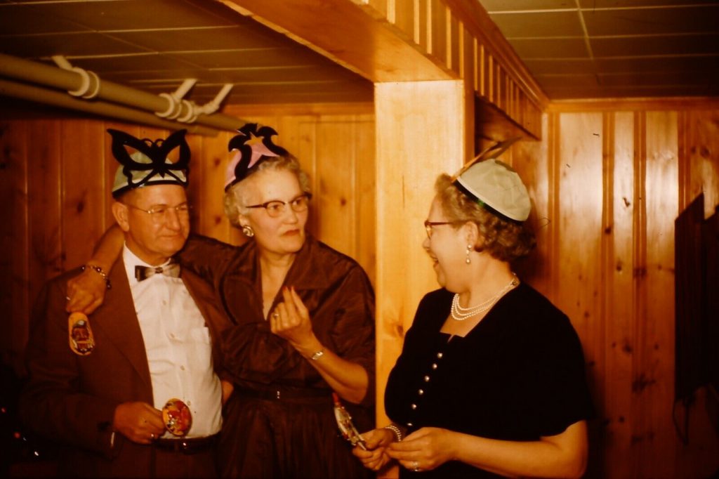 1950s vintage photo of a basement New Years Eve Party with older people in Party Hats