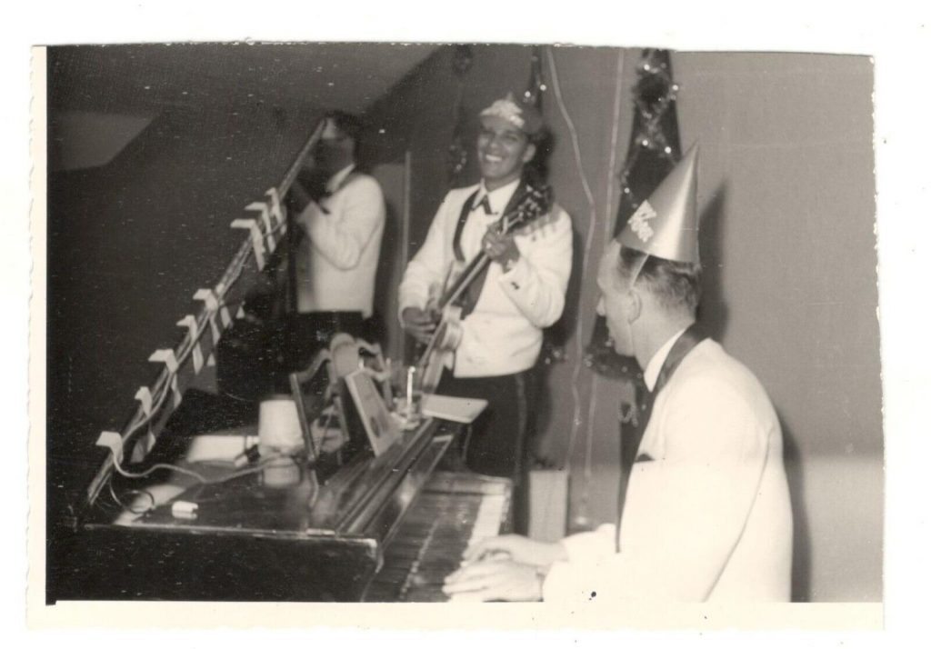 1960s vintage photo: 1960's Band Wearing New Year Eve's wearing Party Hats while playing their music. 