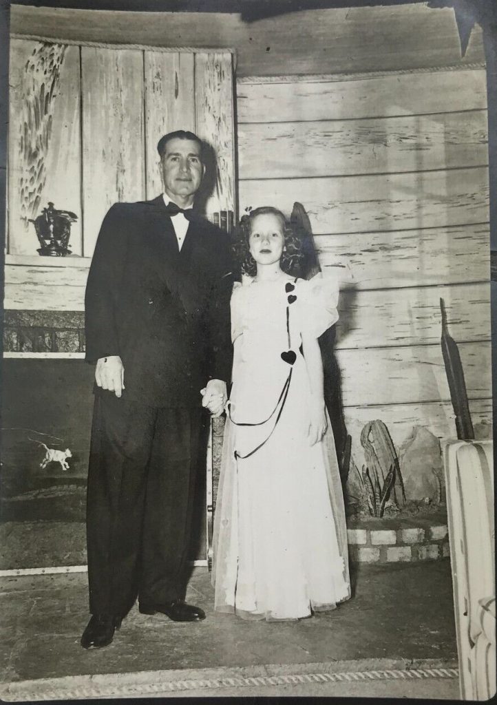 1940s vintage photo: 1947 Daddy, Daughter Valentine's Dance featuring in the photo an adorable girl with her heart dress.