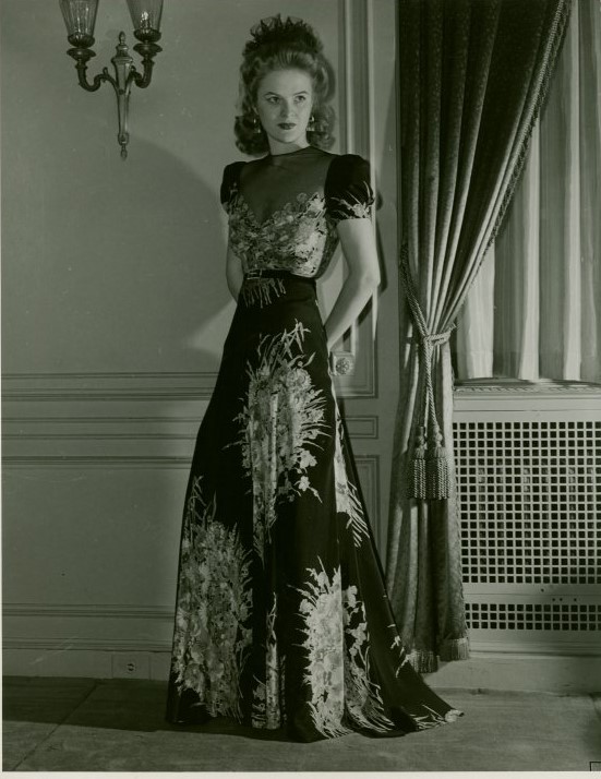 Crepe Dinner gown a Bergdorf Goodman original. 1940s vintage photo of a model in a 1940 evening gown at the World of Fashion exhibit at the New York City's Worlds Fair 1940. Fantastic early 1940s fashion inspiration.