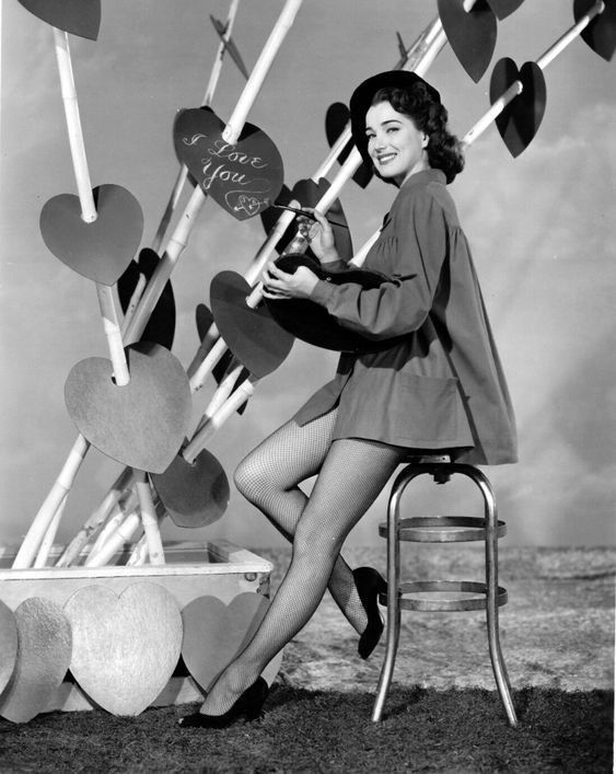 1940s vintage photo of a pin-up for Valentines Days dressed up as a painter. -Vintage Valentine Pin-up photo. 