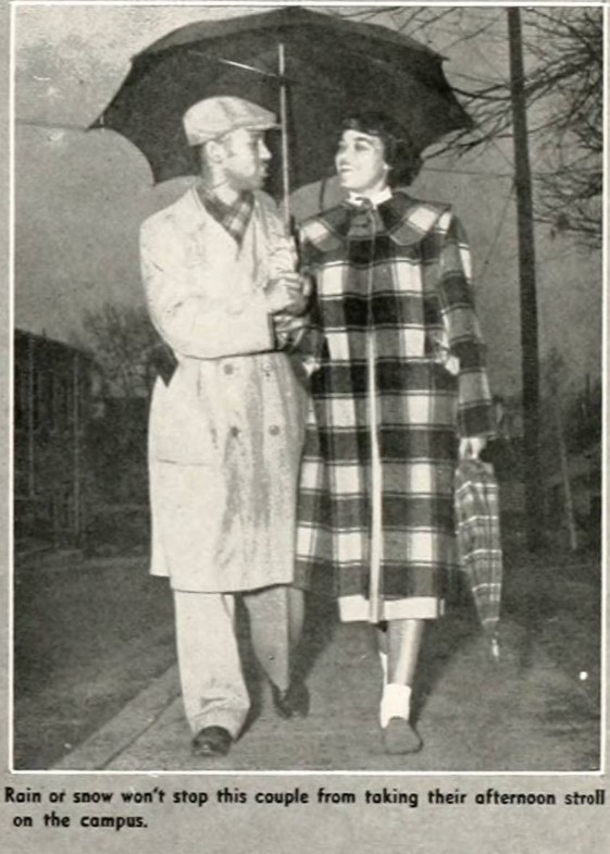 1952 vintage yearbook photo from North Carolina Agricultural and Technical State University of a young Black couple walking together on campus. Our young Black woman is wearing a fantastic long plaid jacket. 1950s Fashion inspiratio