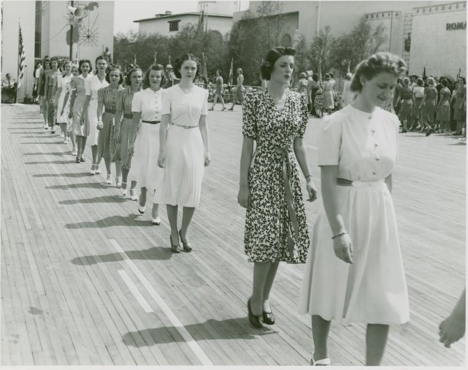 1940s vintage photo: Models at the 1939/1940 New York City Worlds Fair, at the "Take Away a Dress Fashion Show" at Court of Peace. 10,000 eager women spectators waited to hear their numbers drawn to win one of the 400 dresses, bathing suits, beach robes and sports clothes given away.