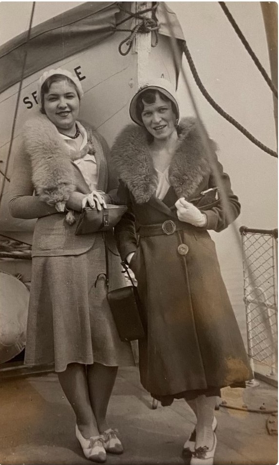 1930s fashion / 1930s Photo of two stylish women in 1930s coats with fur collars, 1930s shoes and 1930s hats posing on a boat