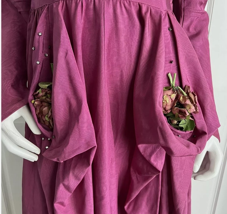 1940s Fashion: A Fred Perlberg 1940s dark mauve moire taffeta dress. The dress is unique, featuring side bustles with faux flower bouquet and rhinestone embellishments. T