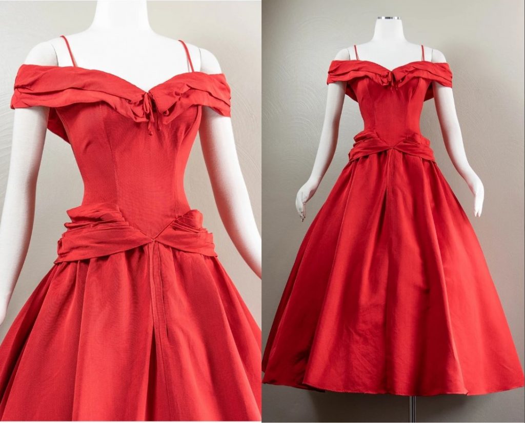 1950s Fashion: A 1950s Fred Perlberg Evening Gown-The dress is a gorgeous red color with spaghetti straps and a pleats off the shoulder sleeves/bertha collar that has a sweet little bow at the center. The bodice is fitted and it has a basque waistline. There are pleated swags on the sides and the skirt is wonderfully full. The dress is ballerina/ankle length and is unlined.