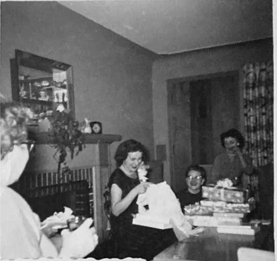 October 1955 Bridal Shower vintage photo. The 1950s vintage image features the bride to be opening her gifts in her mid-century living room