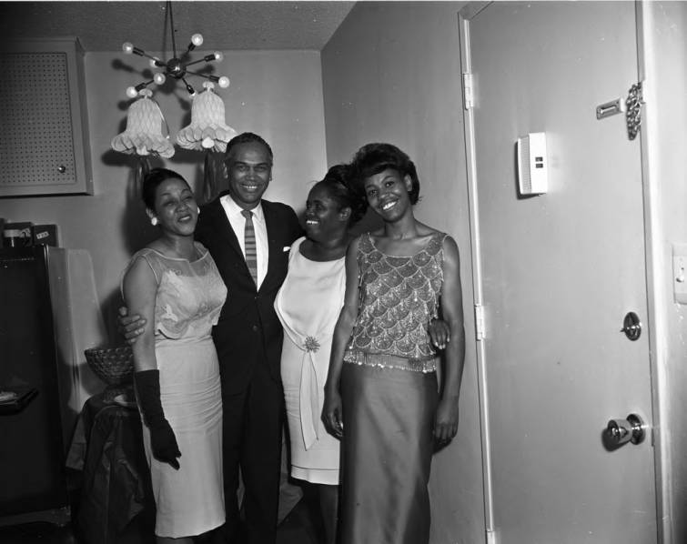 1960s Vintage Photo of Fantastic Black Glamour: Eula and La Doris McClaney (philanthropist) posing with Charles Williams (famous photographer) at a wedding shower, Los Angeles, 1960 in fantastic 1960s fashions.