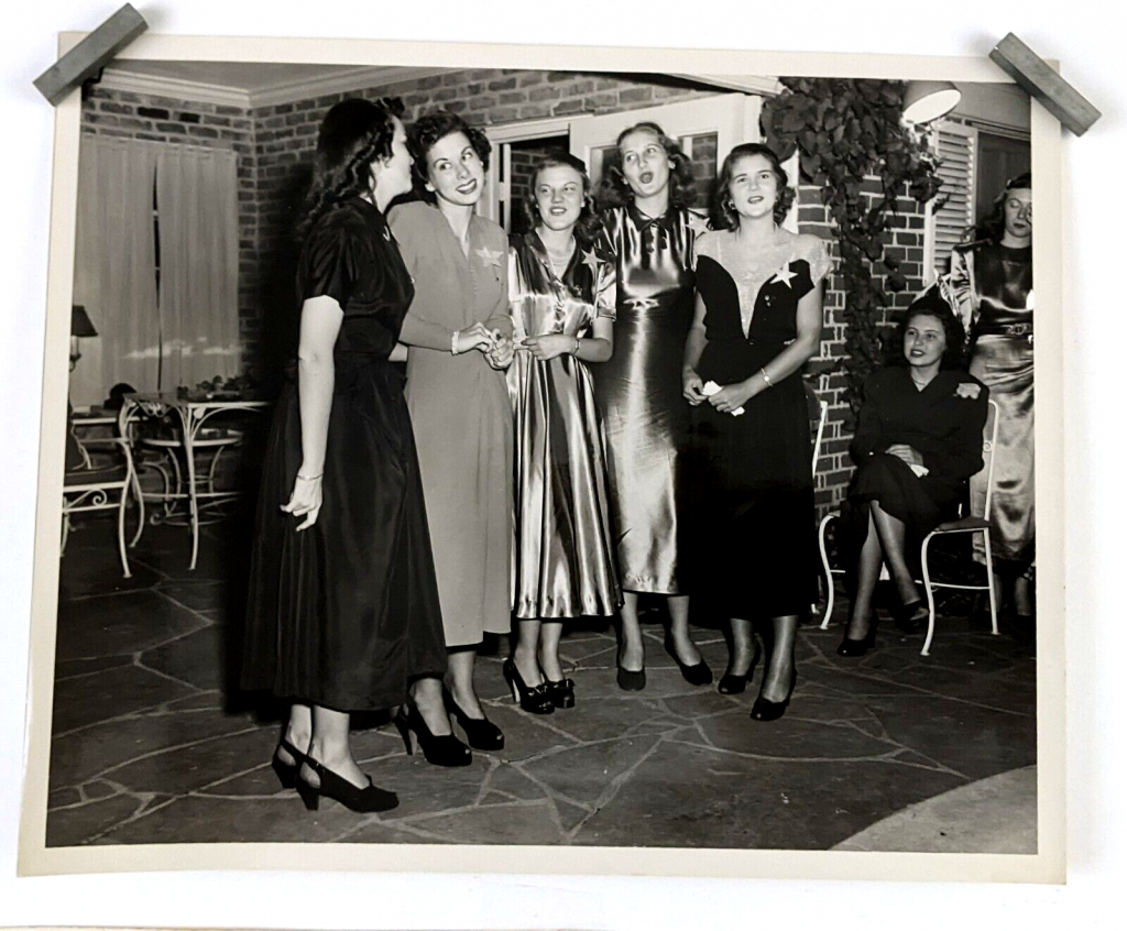 1940s vintage photo of a group of very stylish young women singing a song maybe at a wedding shower, or special gathering. The shoes, the hair and the perfect 1940s dresses are wonderful! Plus super late 1940s vintage hairstyle inspiration