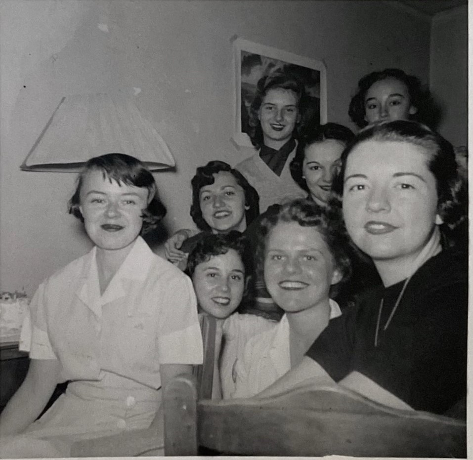 1950s vintage photo of a group of girls in 1950s hairstyles and 1950s fashion posing for the camera at a girls night