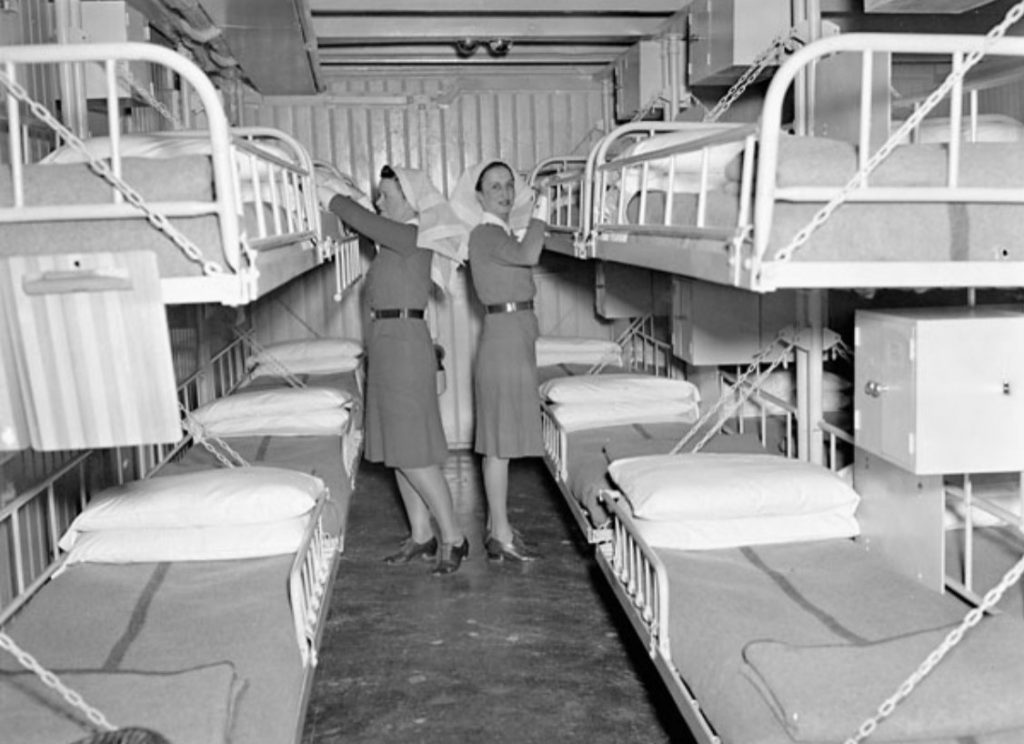 1940s vintage photo: Unidentified Canadian nursing sisters of the Royal Canadian Army Medical Corps awaiting the inspection of one of the wards aboard the hospital ship S.S. LADY NELSON, England, 4 May 1943