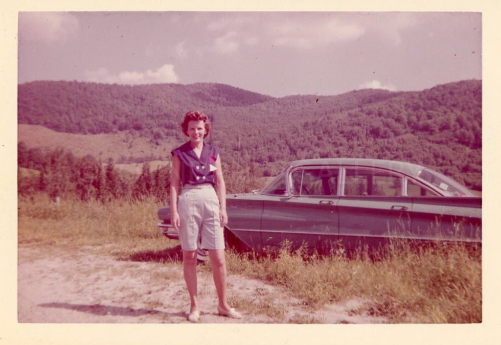 1950s (maybe 1960s) vintage photo of a lady Bermuda shorts (my fav) posing with her car out in the mountainside. 