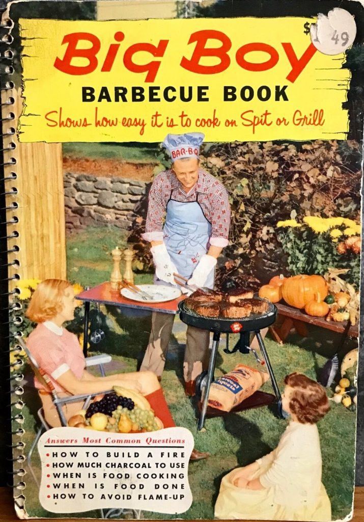 1950s vintage Barbeque cookbook featuring vintage recipes for the bbq or grill -The 1956 Big Boy Barbecue Book. The cover features a dad in a BBQ chefs hat grilling steaks for his family outside. 