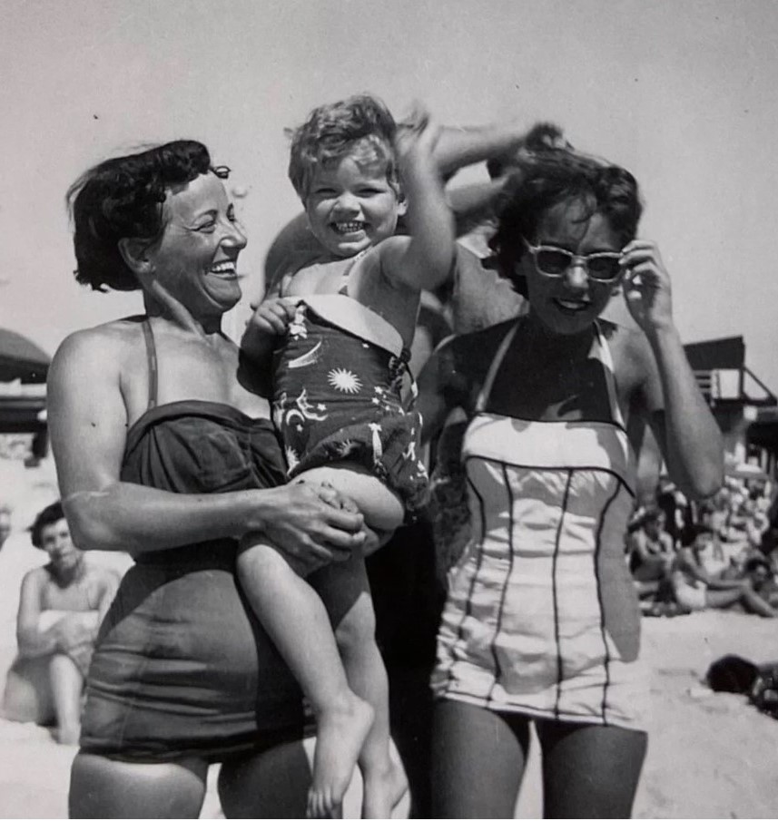 1950s vintage photo of 2 women and little girl in 1950s swimsuits at the beach