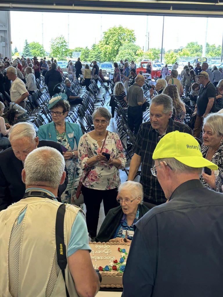 Bomb Girls of Scarborough memorial banner event June 2024. The women in front of the cake is an original Bomb Girl at 102. 