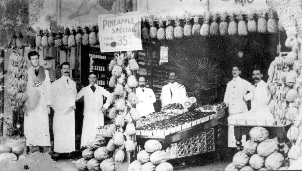 1900s vintage photo of the fruit department featuring a pineapple sale at Woodward's Department store in 1905