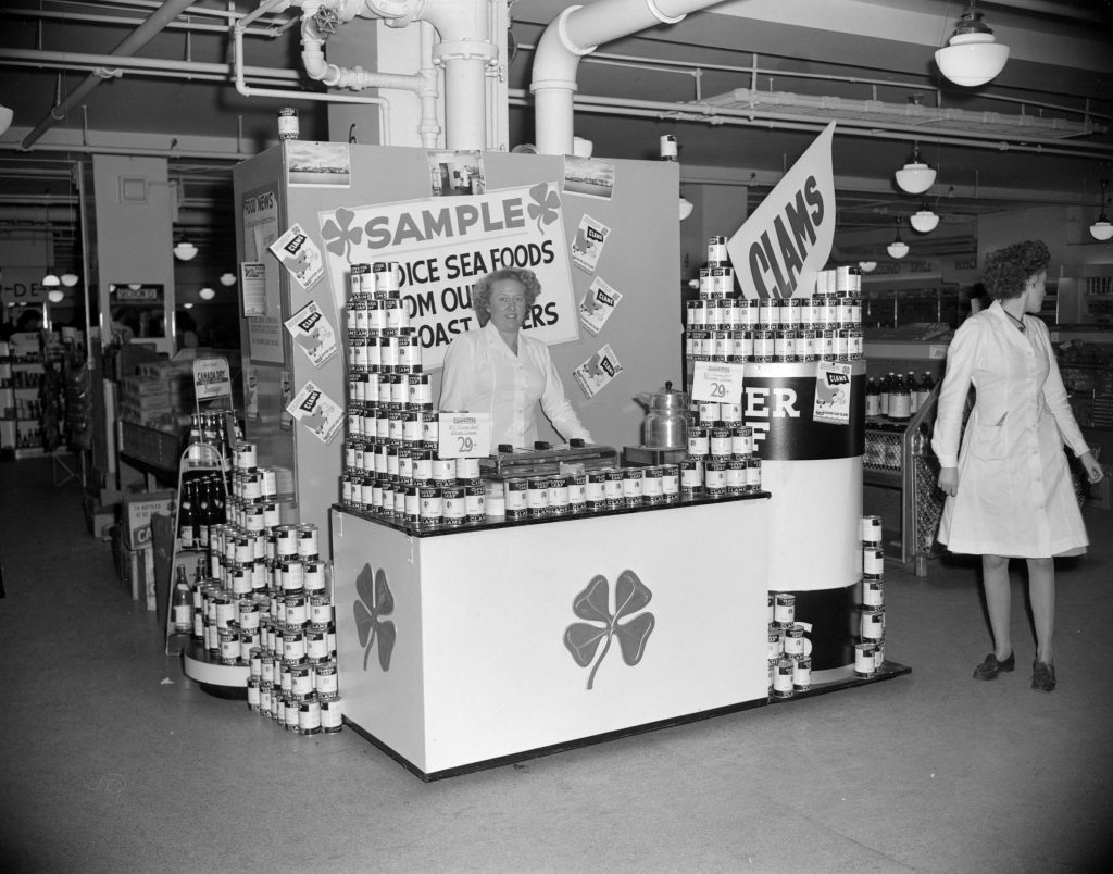 1940s vintage photo: Clover Leaf canned clams sampling display at Woodward's department store in Canada. 