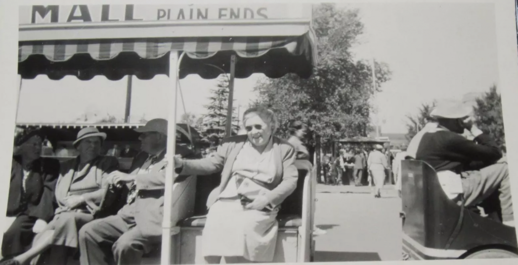  1950s vintage photo of a group of older adults taking a ride on the tram around the CNE-Canadian National Exhibition. Back of the photo has writing saying "Toronto Exhibition".