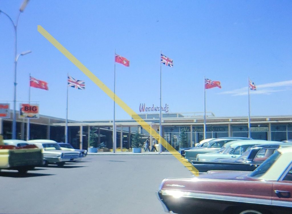 1960s vintage photo-1963 35mm slide of the parking lot and entrance of Woodward's Department Store.