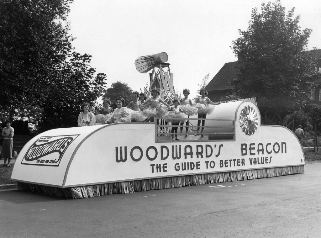 Woodward's Beacon "The guide to better value" parade float. 1940s vintage photo featuring women and young girls on the float for the Canadian department store. 