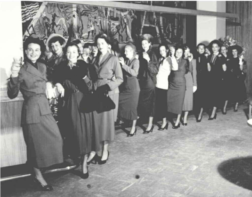 1940s vintage photo of women in 1940s fashions 'Storming the Sazerac' at The Roosevelt Hotel in 1949. ABOUT: Only men were served in the hotel’s classy Sazerac Bar—except for Mardi Gras day —but in 1949, a group of local women were thirsty and looking for sustenance. They stormed the Sazerac Bar demanding equality and a stiff drink.