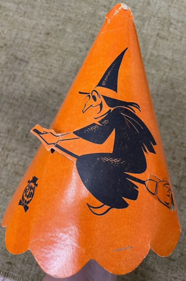 1940s vintage Halloween: 1940s party hat with a very happy witch illustration that is flying out of the hat